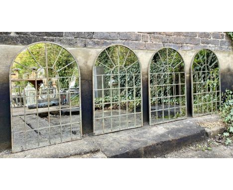 ARCHITECTURAL GARDEN MIRRORS, a set of four, aged metal arched frames, 77cm x 50cm. (4) 