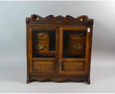 An Edwardian Wall Hanging Oak Smokers Cabinet with Panel Glazed Doors to Fitted Interior Having Four Small Drawers, Raised Ga