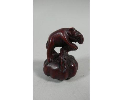 A Carved Wooden Netsuke in the form of a Rat Mounted on a Gourd, 5.5cm High 