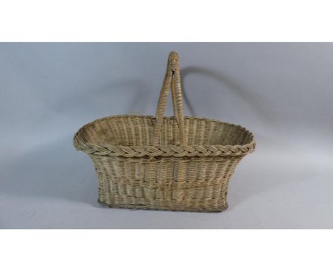 A Vintage Wicker Basket Containing Table Lamp Droppers 