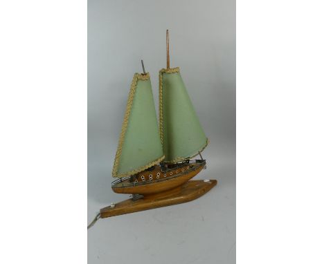 A Novelty Table Lamp in the form of a Two Masted Yacht, on Oak Plinth, 47cm Long 