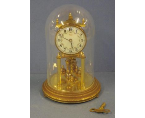 Vintage Kundo mantle clock quartz movement, with enamel face and glass dome casing, together with key, 23cm high
