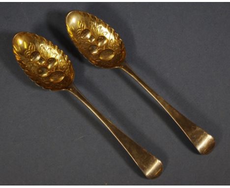 Pair early HM sterling silver berry spoons possibly William & Mary (marks rubbed). Fruit decorated embossed, gilt washed bowl