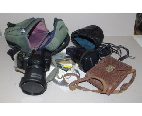 Lumix digital camera DCM FZ720 together with a vintage camera and Lumix camera accessories