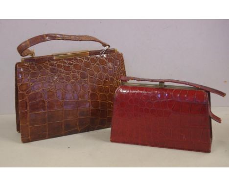 Vintage crocodile skin handbag together with a smaller burgundy coloured crocodile handbag, as inspected