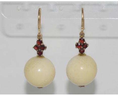 Vintage ivory ball earrings with garnet set bale and 9ct gold hook. NB These may not be exported without CITES documentation.
