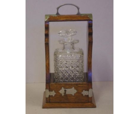 Victorian single decanter tantalus in oak case with metal fittings and key, 34cm high