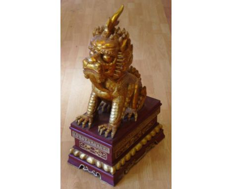 Large Chinese carved gilt temple lion statue on stand, H74cm approx