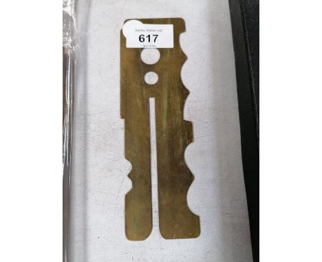A VINTAGE BRASS BUTTON GUARD 