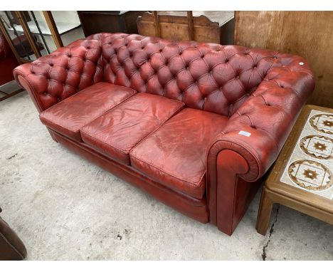 A RED LEATHER BUTTON BACK CHESTERFIELD SOFA 