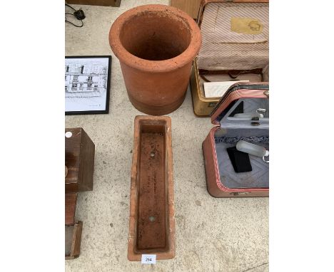 A TERRACOTTA POT AND TERRACOTTA TROUGH 