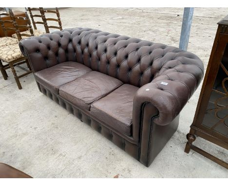 A BROWN LEATHER LOW BUTTON BACK CHESTERFIELD THREE SEATER SOFA 