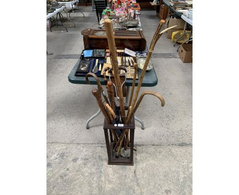 A STICK STAND TOGETHER WITH ASSORTED WALKING STICKS 