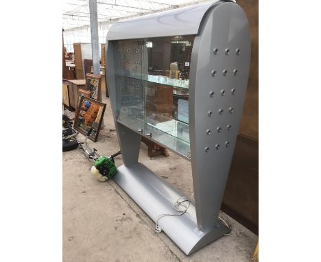 AN UNUSUAL SHOP DISPLAY CABINET WITH TWO GLASS SHELVES AND LIGHTING 