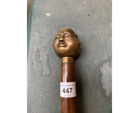 A FOUR FACED BUDDAH HANDLED WALKING STICK 