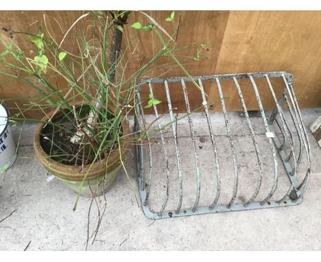 A VINTAGE METAL HAY RACK AND A PLANTER 