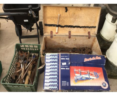 A WOODEN TOOL BOX WITH SPANNERS, A FURTHER BASKET WITH SPANNERS AND A BOXED MITRE SAW 
