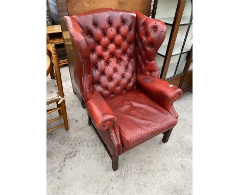 AN OX BLOOD LEATHER BUTTON AND WING BACK CHESTERFIELD ARMCHAIR 
