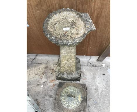 A SUNDIAL ON A CONCRETE BASE AND A CONCRETE BIRD BATH 