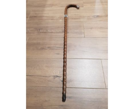 A WALKING STICK WITH HALLMARKED SILVER COLLAR AND HANDLE