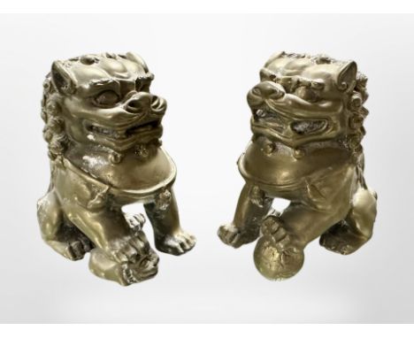 A pair of Chinese cast-bronze seated foo dogs, height 7cm.