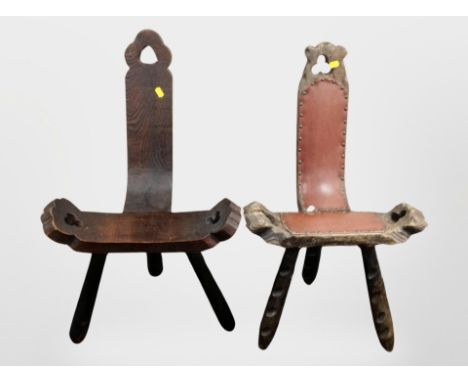 Two early 20th-century carved and stained pine tripod stools.
