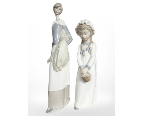 Two Nao figures depicting a lady holding corn and a child holding a basket.