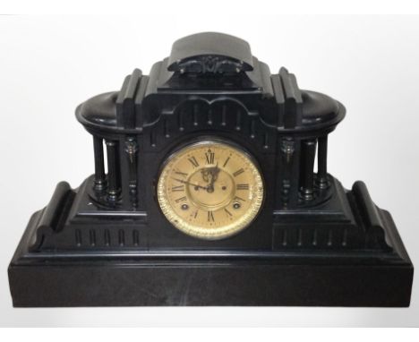 A 19th-century slate mantel clock with visible escapement to dial, height 35cm.