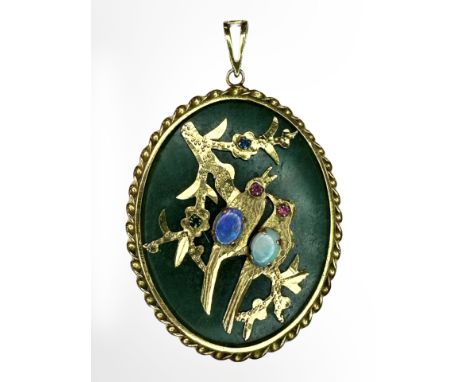 A Chinese jade and gilt metal oval pendant, depicting two birds perched on a branch and inset with gemstones, 63mm by 42mm