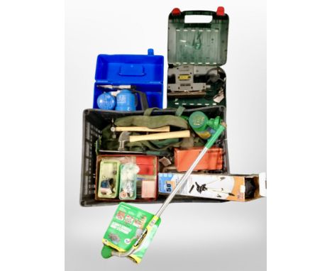 A box of tools including Bosch sander, plant-watering lance, hand tools, collapsible camera tripod, etc.