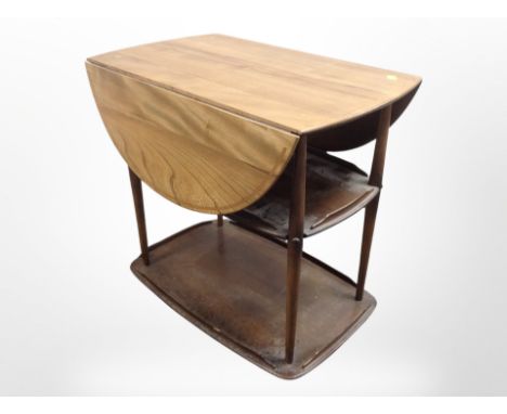 An Ercol elm drop-leaf serving trolley, 73cm x 45cm x 73cm (unfolded).