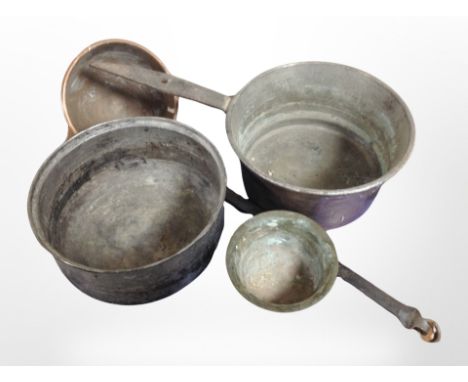 A 19th-century copper cast iron-handled cooking pan, further ladle, a pewter bowl, and a brass bowl.