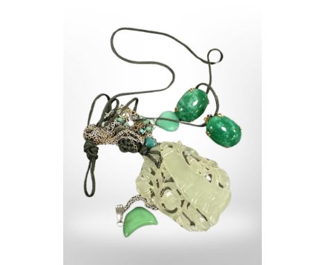 A large carved Chinese jade pendant, a carved crescent jade on silver chain, and a similar faceted pair of Chinese gilt and j
