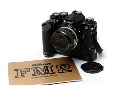 A Nikon FM2 SLR Camera, black, with Nikkor AIS f/3.5 28mm lens and MD-12