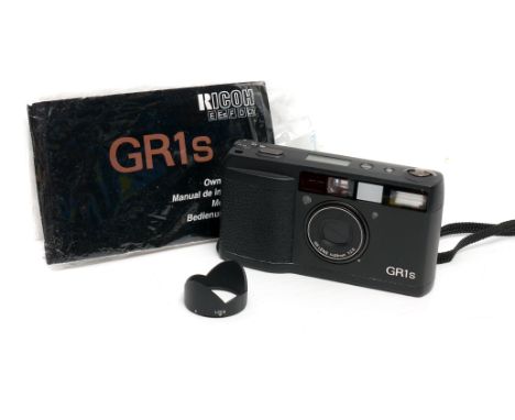 A Ricoh GR1s Compact Camera, with lens hood and instructions