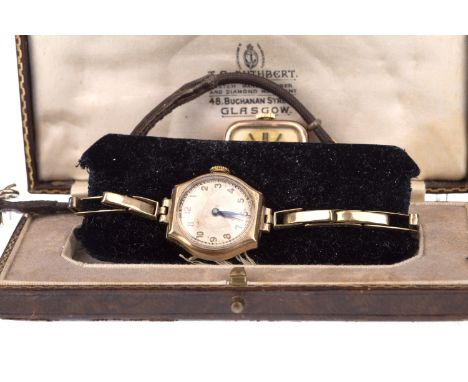 LADY'S NINE CARAT GOLD MANUAL WIND WRIST WATCH, the round white dial with applied gold Arabic numerals, railroad outer second