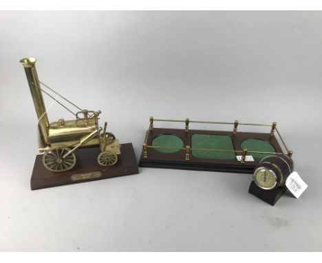 BRASS MODEL OF STEPHENSON'S ROCKET, 26cm high, along with a bottle/decanter stand and a barrel shaped thermometer (3)