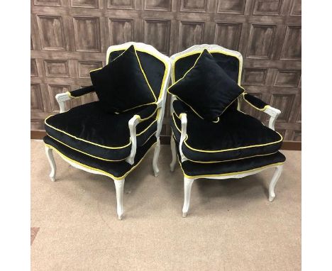 PAIR OF WHITE PAINTED ARMCHAIRS, of French design, with black and gold upholstered cushion seats