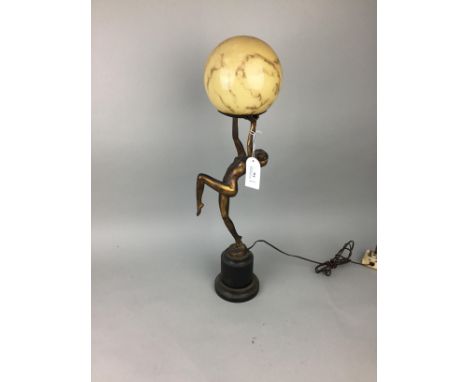 ART DECO GILT METAL LAMP, in the form of a dancing female holding aloft a mottled glass spherical shade, 59cm high