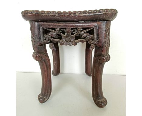 A Chinese carved hardwood stand, the top inset with marble, 19 cm wide