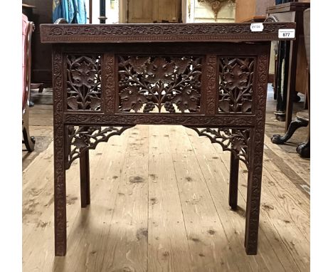 A carved Indian tray top folding table, 61 cm wide