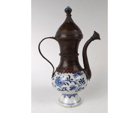 A Moorish style ewer, the porcelain body decorated in underglaze blue and with metal mounts, 21 cm highAll a little loose, ge