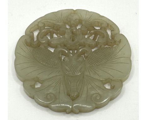 A Chinese pale hardstone pierced plaque, decorated butterflies, 6 cm diameter