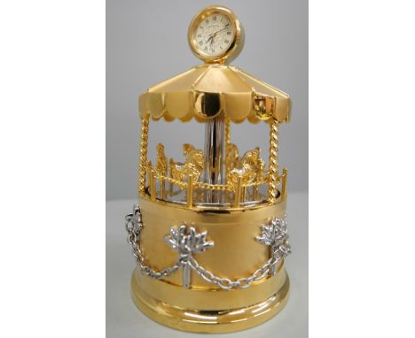 A Sankyo musical table clock in the form of a carousel 