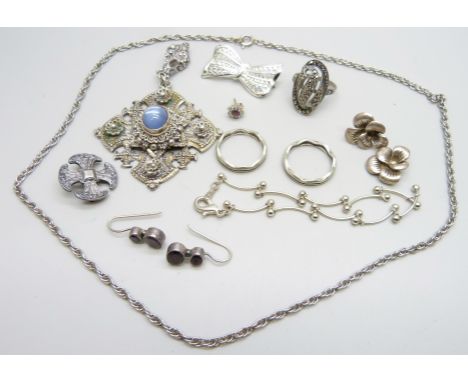 A large stone set cross pendant, a silver cross brooch, a silver ring, etc.