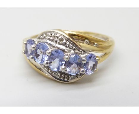 A silver gilt ring set with tanzanite and diamond accents, M