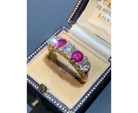 An 18ct gold Victorian style ring, the chased setting with three diamonds and two rubies.
