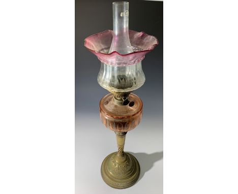 A Victorian oil lamp, with red tinted font, brass column and base and cranberry tinted shade. (Dimensions: Height&nbsp;&nbsp;