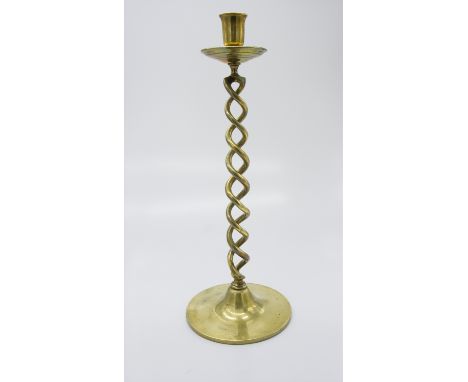 A large brass candlestick with twisted stem. (Dimensions: Height 48cm.)(Height 48cm.)