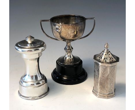 A silver pepper grinder, an engraved silver pepper and a small silver twin handled trophy.